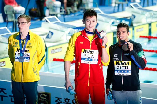 Gold medallist Sun Yang of China, and bronze medallist Gabriele Detti of Italy celebrate as silver medallist Mack Horton of Australia protests on the podium after the Men's 400m Freestyle medal ceremony at the FINA World Swimming Championships at the Nambu University Municipal Aquatics Center, Gwangju, South Korea, on Sunday