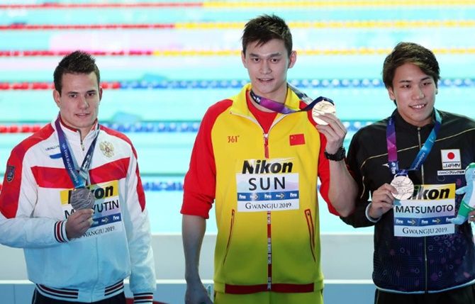 Gold medallist Sun Yang of China, silver medallist Katsuhiro Matsumoto and bronze medallist Martin Malyutin of Russia pose