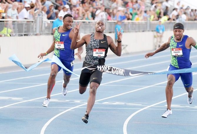 Christian Coleman, centre, breasts the tape ahead of defeats Michael Rodgers, right, and Isiah Young to win the 100 metres in 9.99 at the USATF Championships at Drake Stadium. 