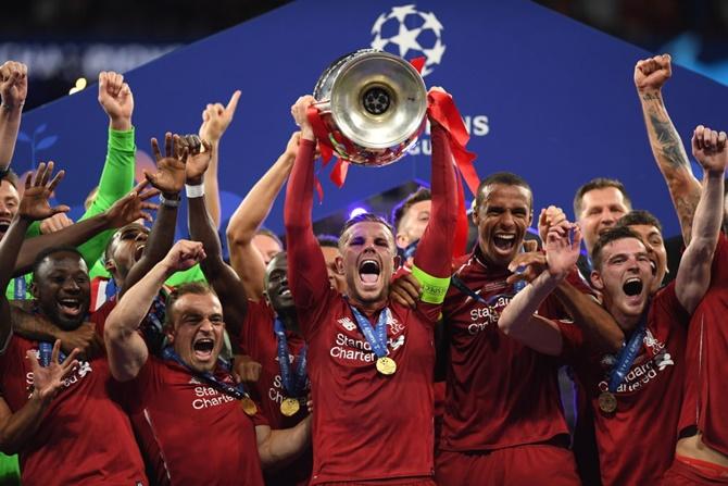 Liverpool players celebrate with the Champions League trophy