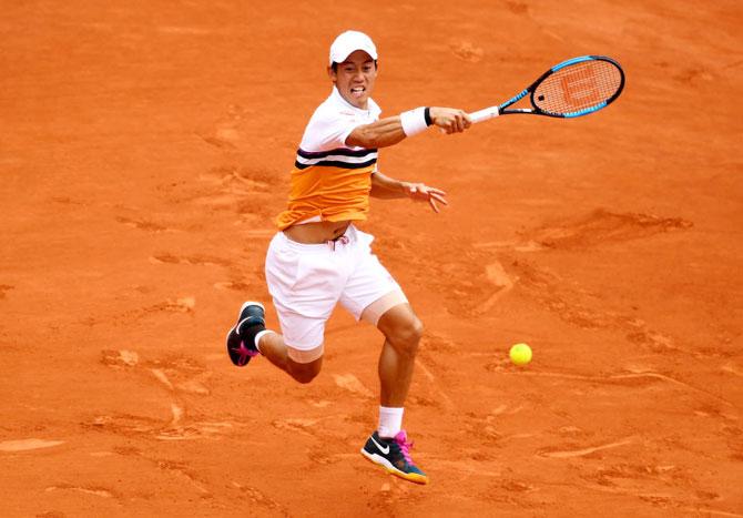 Japan's Kei Nishikori plays a forehand return