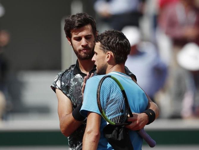 Dominic Thiem and Russia's Karen Kachanov, left, embrace after their quarter-final.