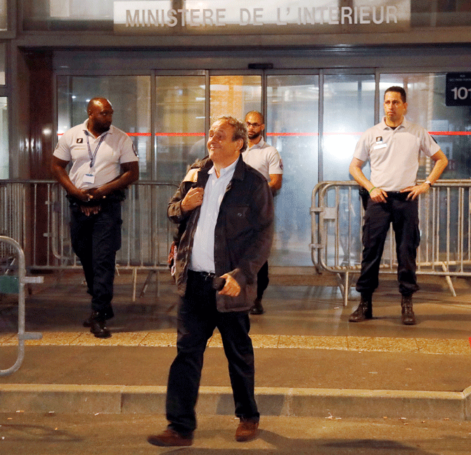Former head of European football association UEFA Michel Platini leaves a judicial police station on Wednesday, where he was detained for questioning over the awarding of the 2022 World Cup soccer tournament, in Nanterre, France