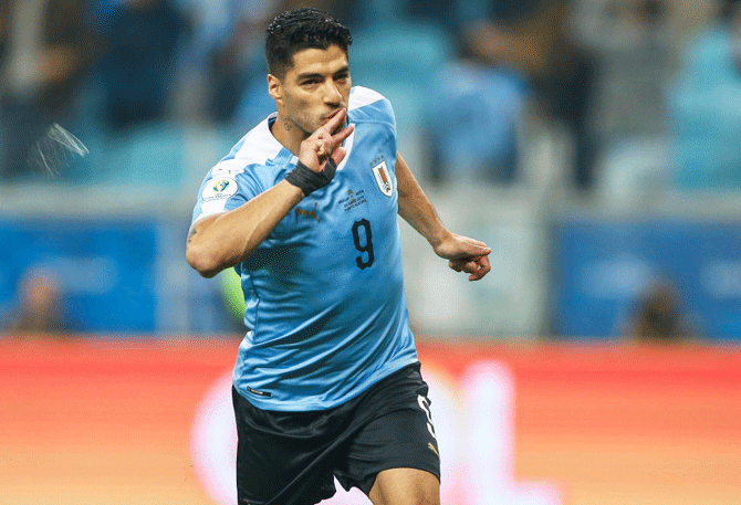 Uruguay's Luis Suárez celebrates after scoring his team's first goal against Japan during their Copa America Group C match at Arena do Gremio stadium in Porto Alegre, Brazil, on Thursday