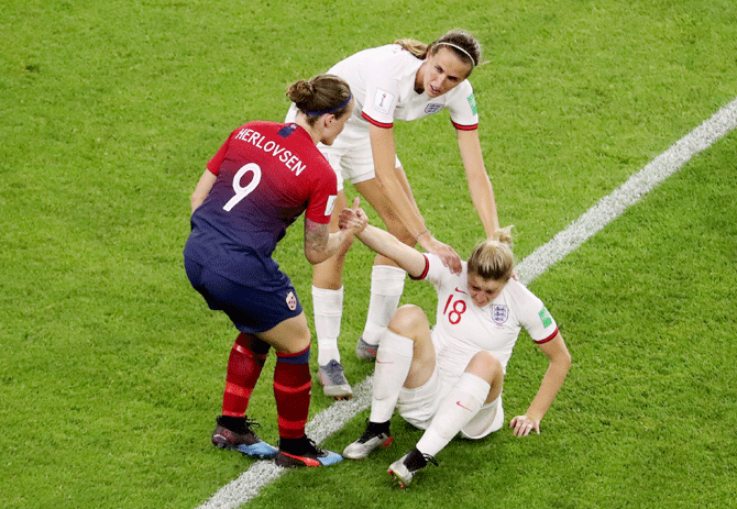 Norway's Isabell Herlovsen helps up England's Ellen White as England's Jill Scott looks on during their FIFA Women's World Cup quarter-final at Stade Oceane, Le Havre, France, on Thursday
