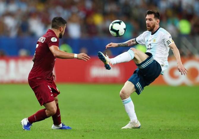 Argentina's Lionel Messi in action with Venezuela's Junior Moreno