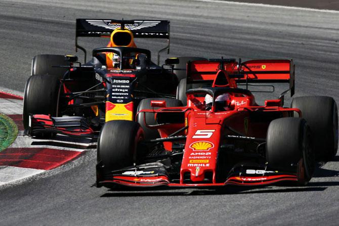 Sebastian Vettel driving the (5) Scuderia Ferrari SF90 leads Max Verstappen driving the (33) Aston Martin Red Bull Racing RB15 on track during the Austrian F1 Grand Prix at Red Bull Ring