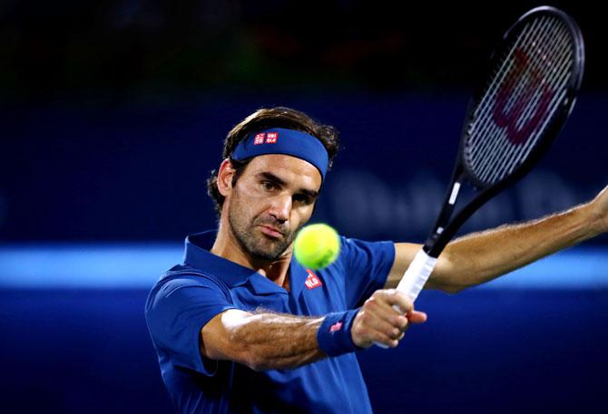 Switzerland's Roger Federer plays a backhand against Hungary's Marton Fucsovics on Day 12 of the ATP Dubai Duty Free Tennis Championships at Dubai Duty Free Tennis Stadium in Dubai on Thursday