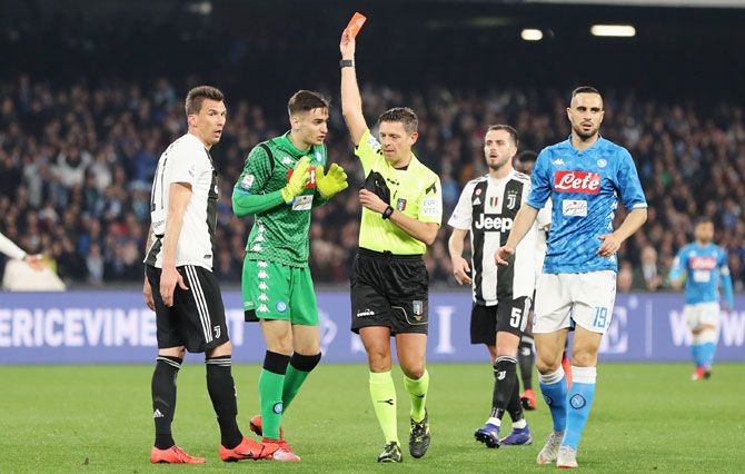 Referee Gianluca Rocchi shows the red card to SSC Napoli's Alex Meret during the Serie A match between SSC Napoli and Juventus at Stadio San Paolo in Naples, Italy, on Sunday
