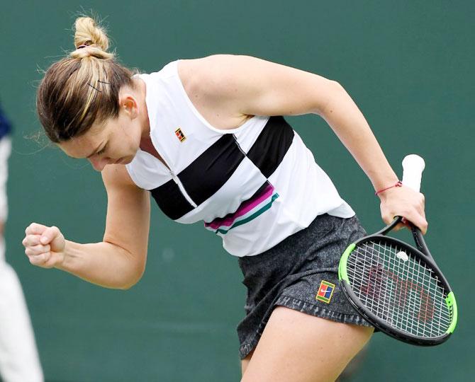 Romania's Simona Halep reacts after winning the first set tie breaker against Kateryna Kozlova in her second round match in the BNP Paribas Open at the Indian Wells Tennis Garden in Indian Wells, California, on Sunday