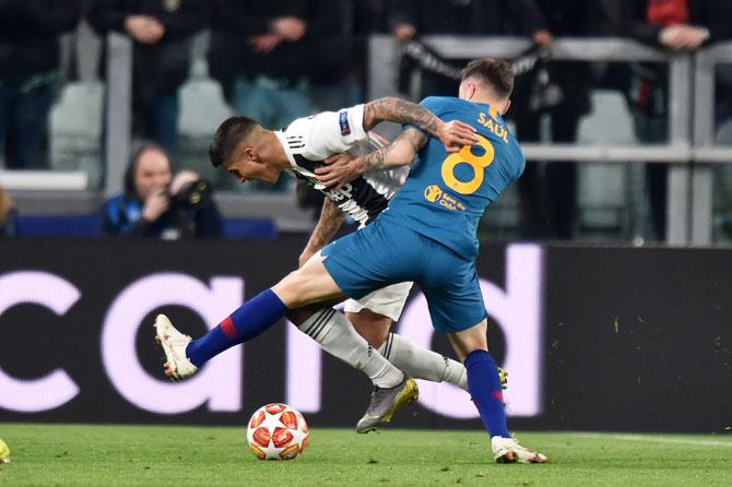 Juventus' Joao Cancelo (left) and Atletico Madrid's Saul Niguez compete for the ball