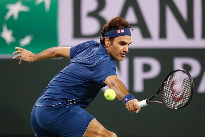 Switzerland's Roger Federer stretches for a backhand return against Switzerland's Stan Wawrinka during their men’s singles third round match