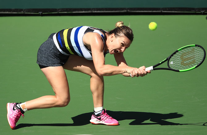 Romania's Simona Halep grimaces as she hits a backhand against Czech Republic's Markéta Vondroušová during their women's singles fourth round match