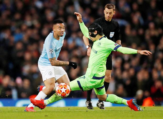 Manchester City's Gabriel Jesus and Schalke's Benjamin Stambouli vie for possession