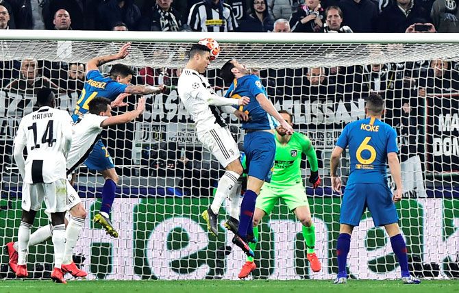 Juventus' Cristiano Ronaldo heads in to score their second goal against AtleticO Madrid