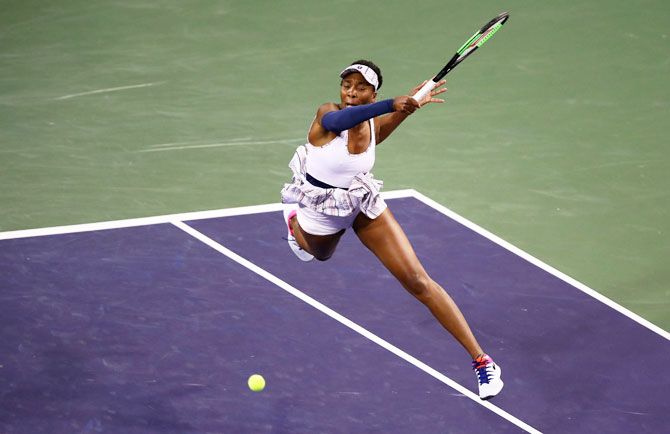 USA's Venus Williams plays a forehand against Germany's Mona Barthel during their women's singles fourth round match