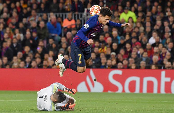 Barcelona's Philippe Coutinho is challenged by Olympique Lyonnais' Anthony Lopes