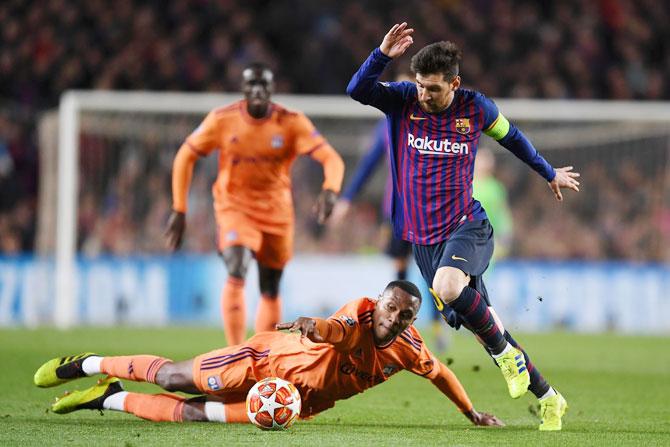 Lionel Messi evades Olympique Lyonnais' Marcelo as he presses forward during their UEFA Champions League Round of 16 second leg match against Olympique Lyonnais at Nou Camp in Barcelona on Wednesday