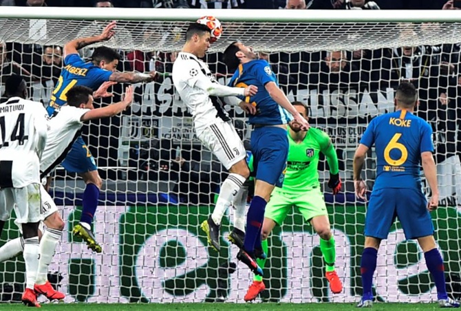 Juventus' Cristiano Ronaldo scores off a header