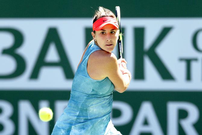 Switzerland's Belinda Bencic returns a shot against Czech Republic's Karolina Pliskova in their semi-final at the Indian Wells Tennis Garden