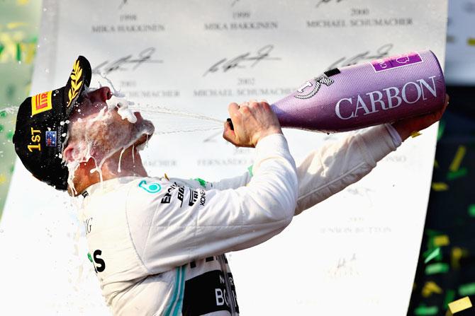 Mercedes GP'S Finnish driver Valtteri Bottas celebrates on the podium after winning the Australian F1 Grand Prix at Albert Park in Melbourne on Sunday