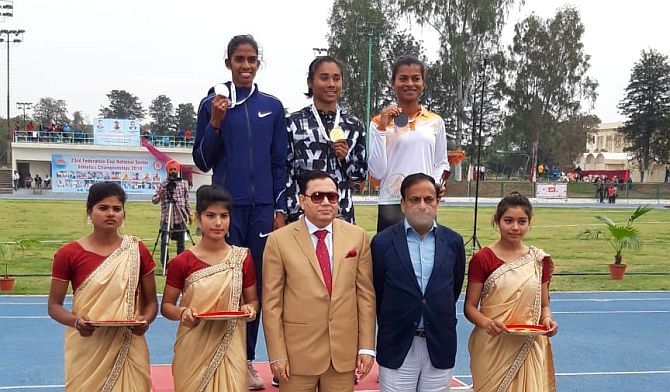 Hima Das (centre) won gold in the 400m event on Monday. Here she is on the podium with the silver and bronze medallists