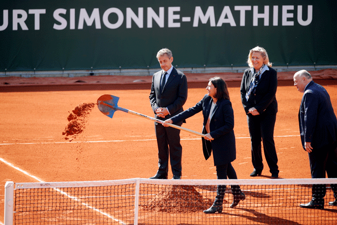 Former French Nicolas Sarkozy, Paris Mayor Anne Hidalgo, French Tennis Federation president Bernard Giudicelli and Paris 16th district mayor Daniele Giazzi attend the opening ceremony of the new court Simonne Mathieu at Roland Garros stadium in Paris on Thursday