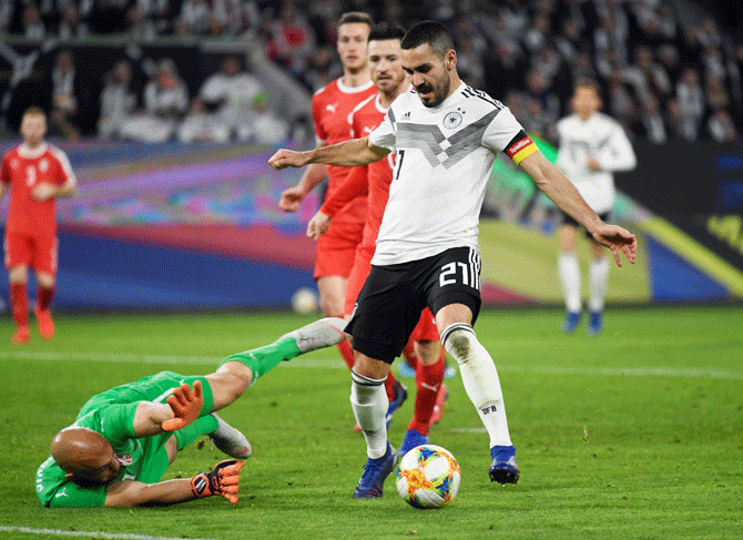 Germany's Ilkay Gundogan and Serbia's Marko Dmitrovic vie for possession during their international friendly at Volkswagen Arena, Wolfsburg, Germany on Thursday