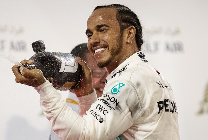 Great Britain and Mercedes GP's Lewis Hamilton celebrates on the podium after winning the F1 Grand Prix of Bahrain at Bahrain International Circuit in Manama, Bahrain on Sunday