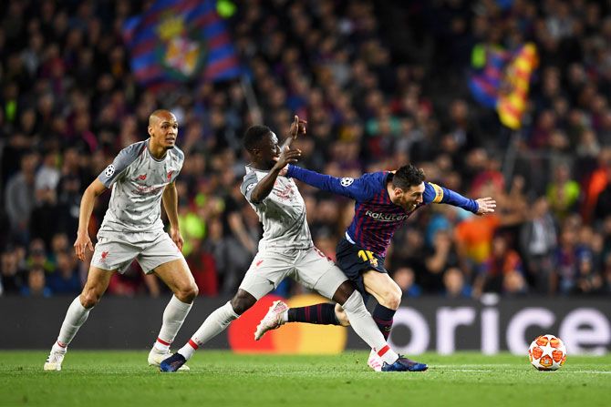 Liverpool's Naby Keita challenges Barcelona's Lionel Messi