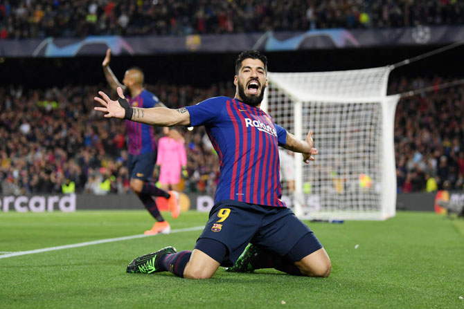 Barcelona's Luis Suarez  celebrates after he scores the first goal against Liverpool during the UEFA Champions League semi-final first leg match at the Nou Camp in Barcelona, Spain, on Wednesday