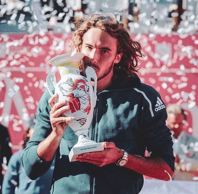 Greece's Stefanos Tsitsipas celebrates with the trophy after winning the Estoril Open on Sunday