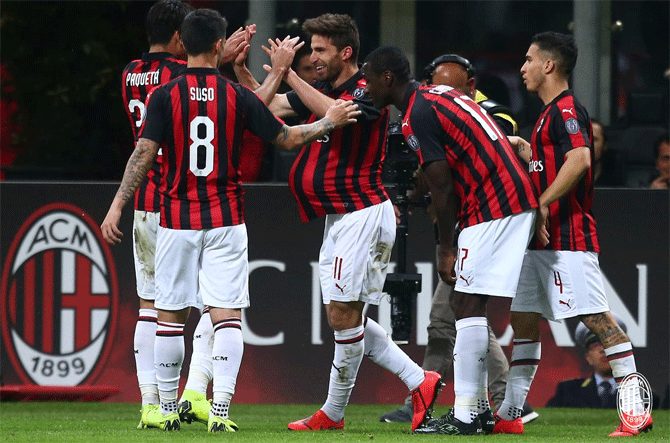 AC Milan's Fabio Borini celebrates with teammates after scoring against Bologna in their Serie A match on Monday