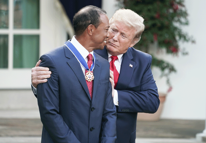 US President Donald Trump presents professional golfer and business partner Tiger Woods with the Medal of Freedom during a ceremony in the Rose Garden at the White House in Washington, DC on Monday. Trump announced he would give the nation’s highest civilian honor to Woods, 43, in honor of his Masters victory last month