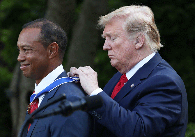 US President Donald Trump gives professional golfer and business partner Tiger Woods the Medal of Freedom