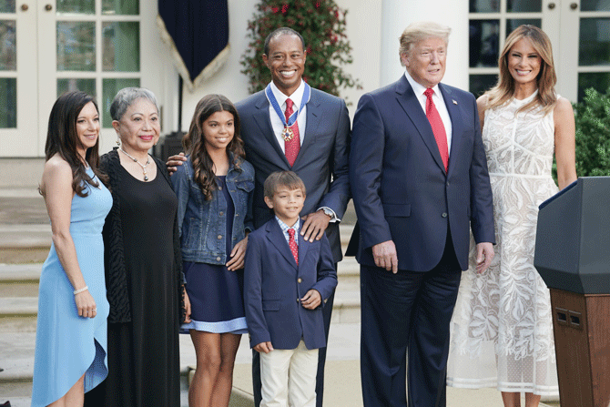 Tiger Woods is flanked by girlfriend Erica Herman, mother Kultida Woods, son Sam Alexis Woods, daughter Charlie Axel Woods, US President Donald Trump and first lady Melania Trump after the presentation ceremony