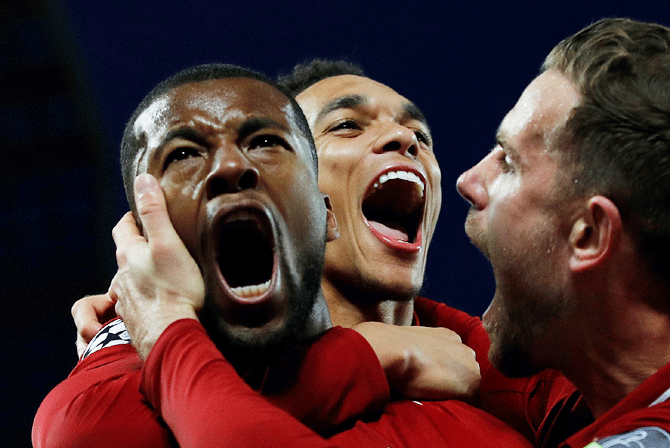 Liverpool's Georginio Wijnaldum celebrates with Jordan Henderson and Trent Alexander-Arnold after scoring their third goal against Barcelona during their Champions League semi-final second leg  match at Anfield in Liverpool on Tuesday