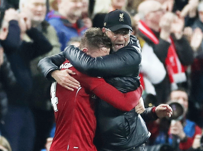 Liverpool manager Juergen Klopp and celebrates with captain Jordan Henderson after the UEFA Champions League semi-final second leg match against Barcelona on Tuesday