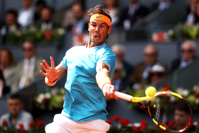 Spain's Rafael Nadal returns playS a return in his match against Canada's Felix Auger-Aliassime  during the Mutua Madrid Open at La Caja Magica in Madrid, Spain, on Wednesday