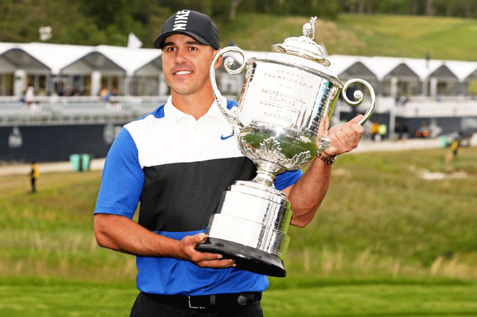 Brooks Koepka celebrates with the Wanamaker trophy after winning the PGA Championship golf tournament at Bethpage State Park in Black Course in Bethpage, New York on Sunday