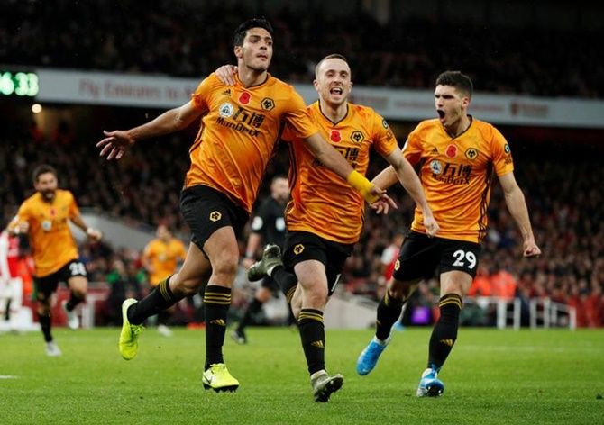 Raul Jimenez celebrates scoring Wolverhampton Wanderers's goal with teammates Diogo Jota and Ruben Vinagre. 