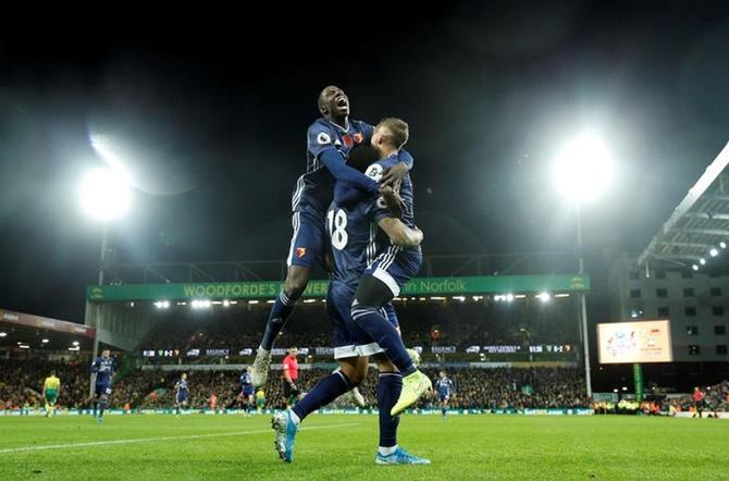 Andre Gray celebrates scoring Watford's second goal with teammates Abdoulaye Doucoure and Gerard Deulofeu