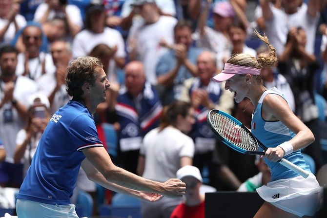 France's Kristina Mladenovic celebrates with France Fed Cup captain Julien Benneteau after defeating Ash Barty of Australia in the 2019 Fed Cup Final tie