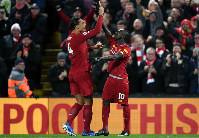 Sadio Mane, right, celebrates after scoring Liverpool's third goal with teammate Virgil van Dijk