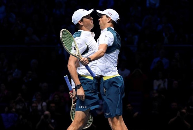 Bob Bryan and Mike Bryan celebrate winning a point.