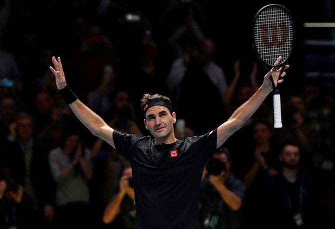 Switzerland's Roger Federer celebrates defeating Serbia's Novak Djokovic in the ATP Finals group stage match