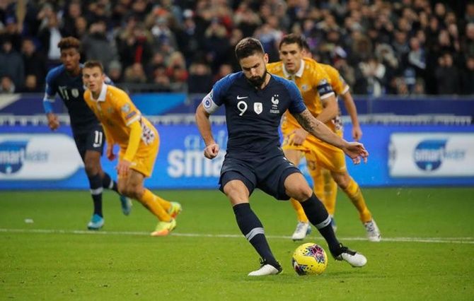 Olivier Giroud takes the penalty kick to score France's second goal against Moldova.