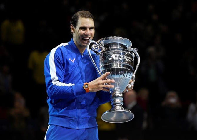 Rafael Nadal celebrates with the ATP World No.1 trophy after winning his group stage match against Stefanos Tsitsipas.