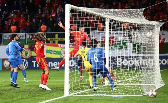 Kieffer Moore scores Wales's first goal.