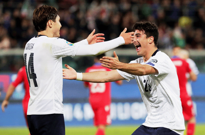 Italy's Riccardo Orsolini celebrates scoring their eighth goal with teammate Federico Chiesa during their Euro 2020 Qualifier Group J match at Stadio Renzo Barbera in Palermo on Monday